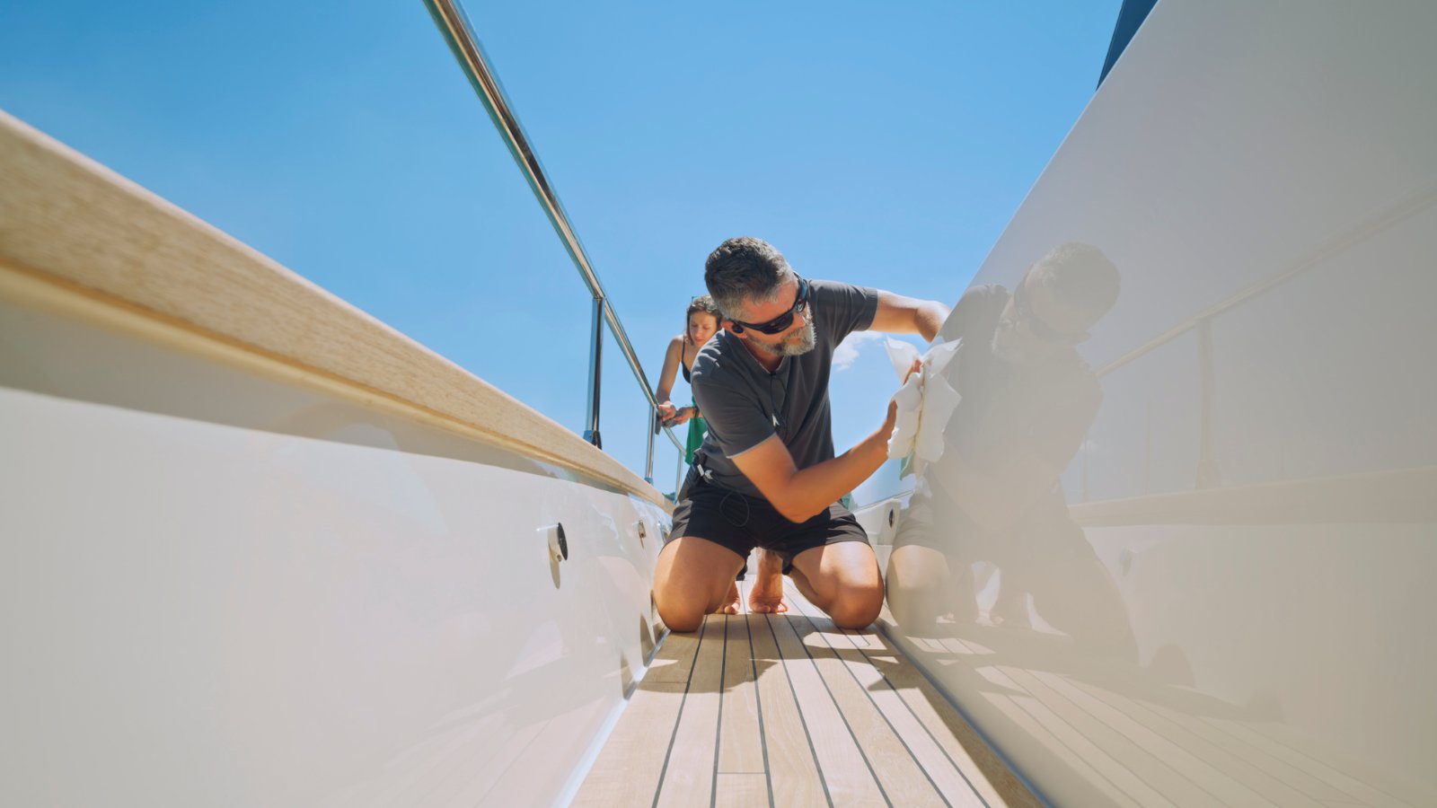 Crew member working on a superyacht deck